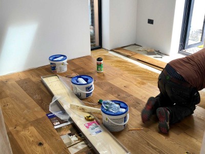 Tradesman installing Wood flooring