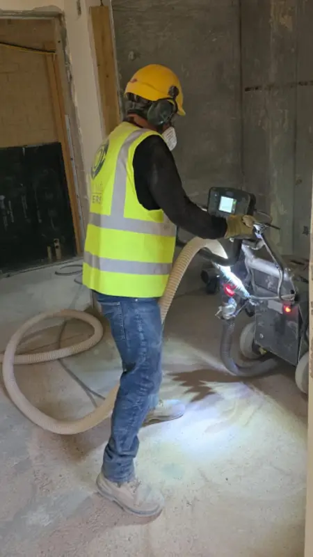 Floor Grinding by Flooring Matters – Employee using equipment Floor Grinding at Exeter University by Flooring Matters