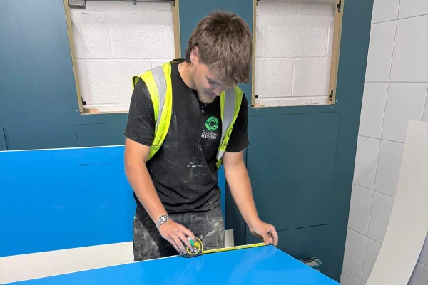Flooring Apprentice Cory Cutting Wall Cladding